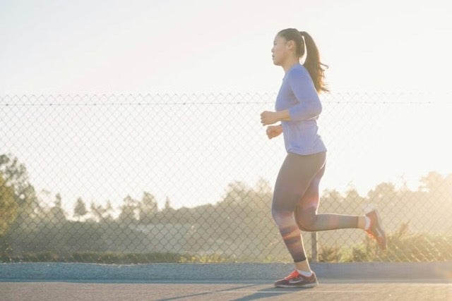 A woman is jogging outdoors