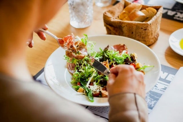 A person is eating salad