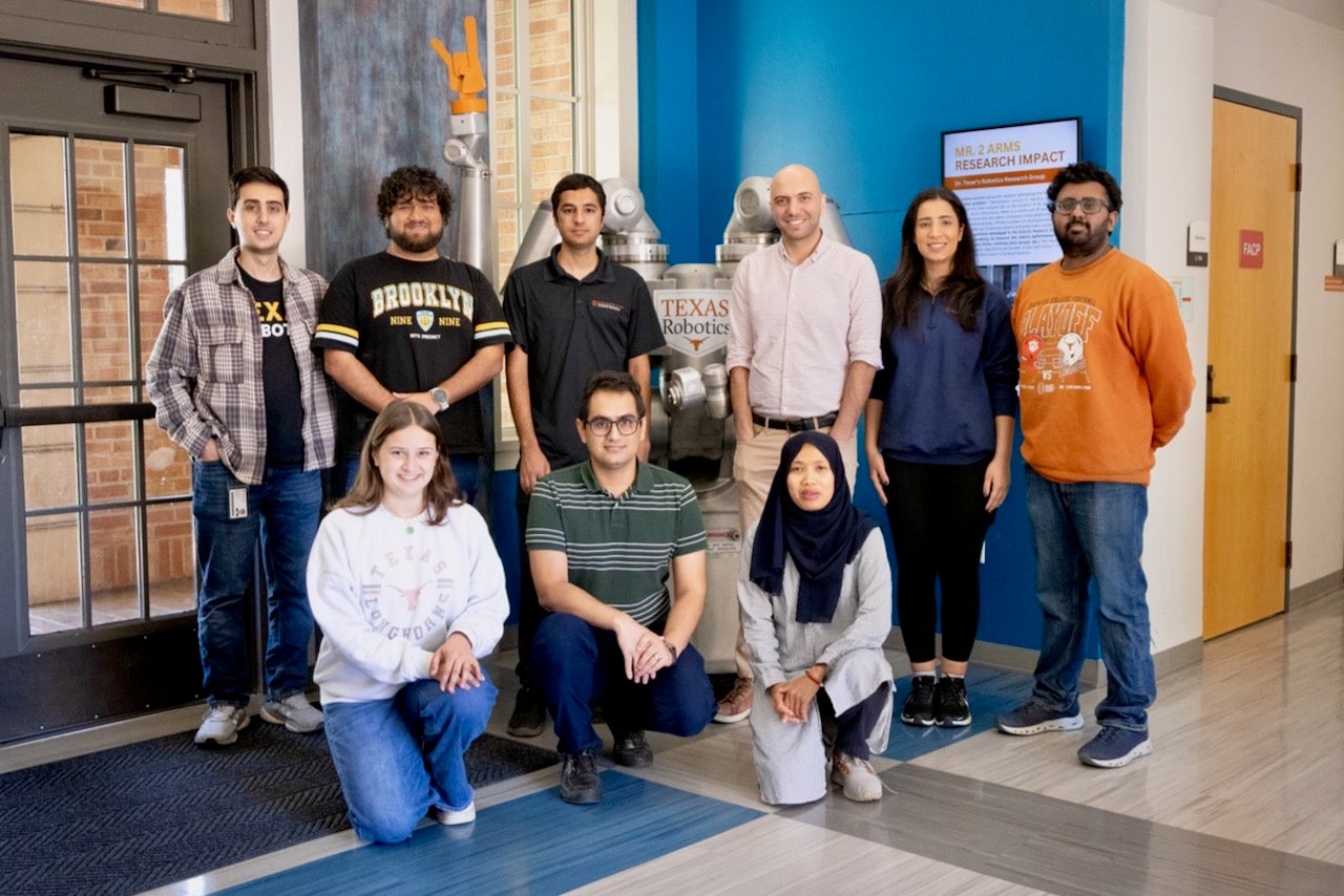 Dr. Farshid Alambeigi and his students pose for a group photo at the Texas Robotics lab.
