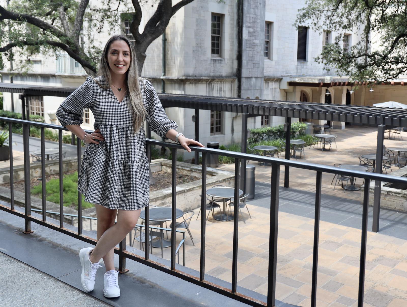 Karen Holguin standing outside the Flawn Academic Center at UT Austin