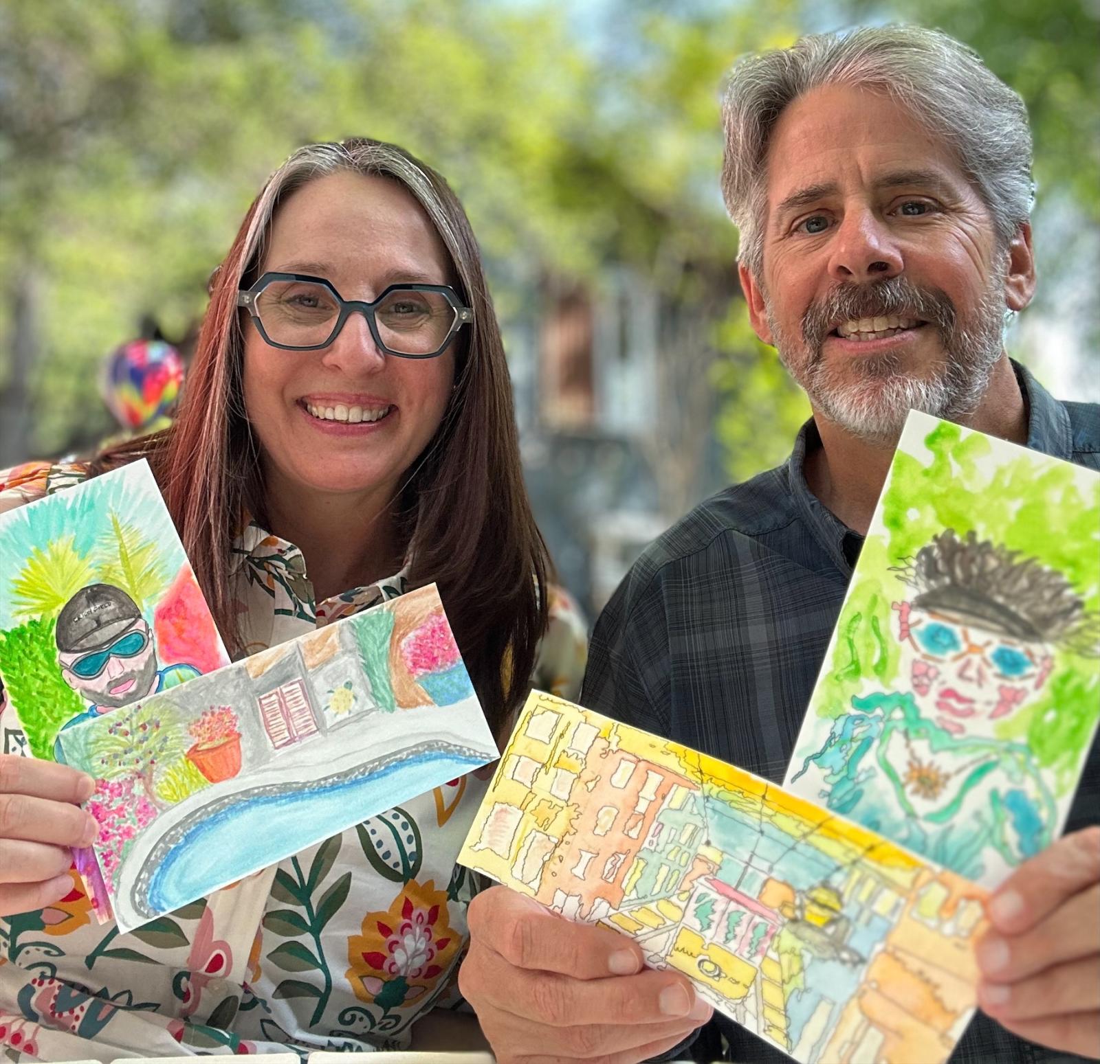 Tania Tost and her husband Paul show off some of their watercolors. Tania Tost and her husband Paul show off some of their watercolors.