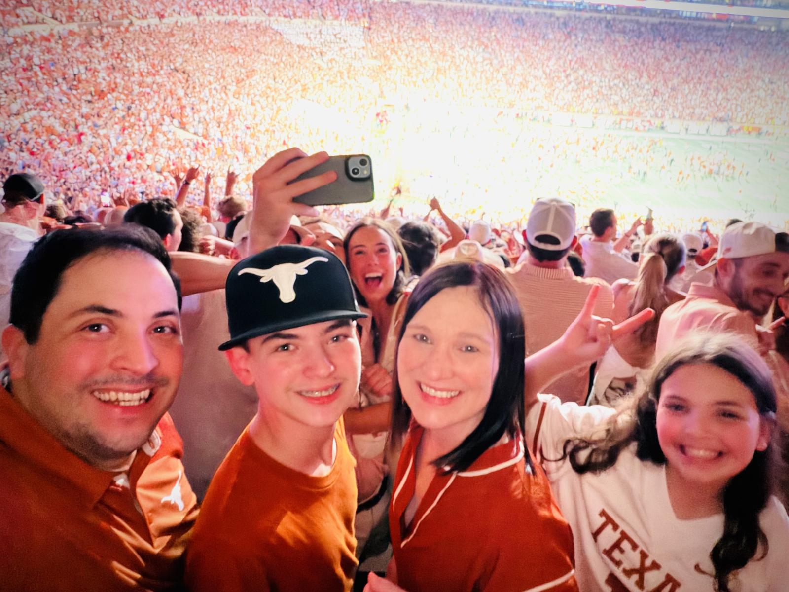 Christian Flores (second from right) at a UT football game with her family: from left, husband Jaime, son JL and daughter Eisley. 